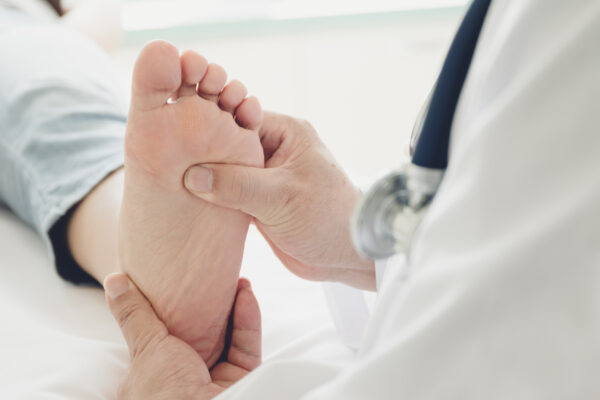 Doctor giving a patient foot check